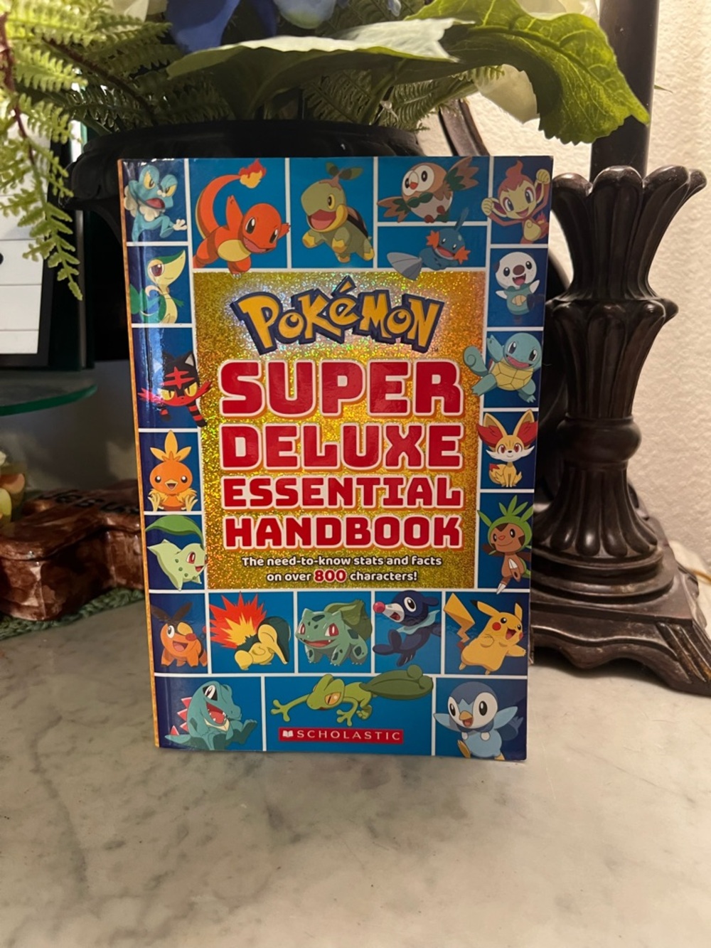 Scholastic Pokémon Super Deluxe Essential Handbook -Holographic cover.